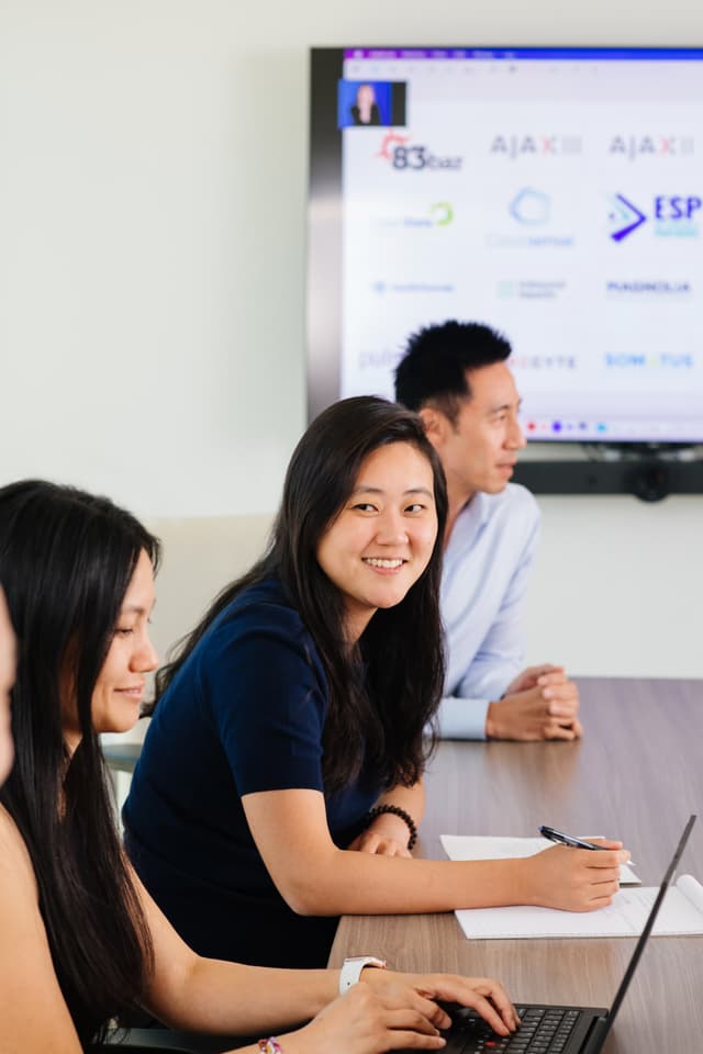 woman leaning on a desk
